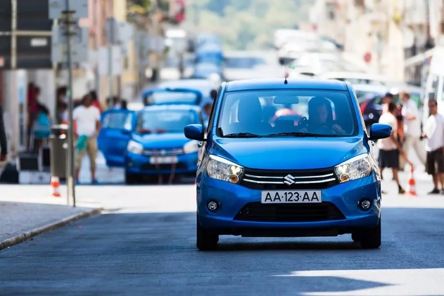 A picture of a Suzuki Celerio travelling on a European city street