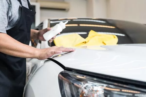 a men creating a protective overlay on his car