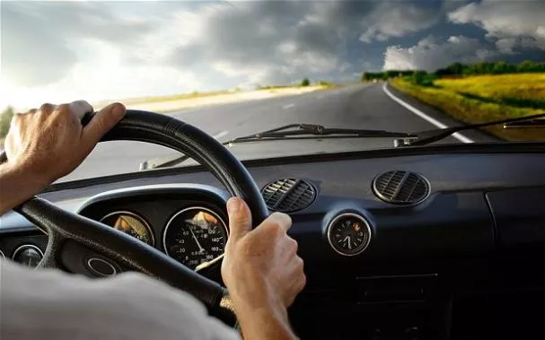 Hold on to the wheel and keep the car straight Driver holding steering wheel