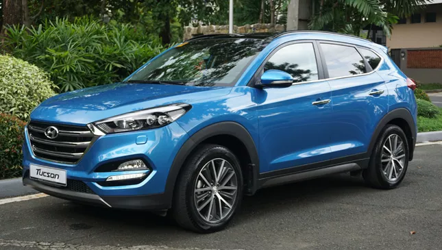 A blue Hyundai Tucson angular front view