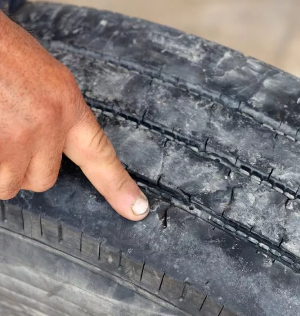 Checking the tread wear in a car tire