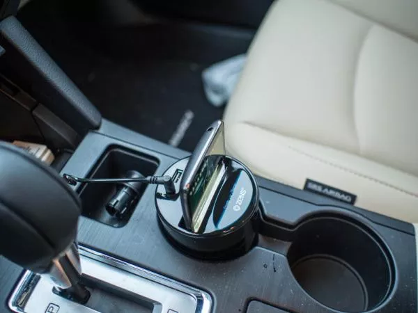 A smart phone charged via USB port in a car